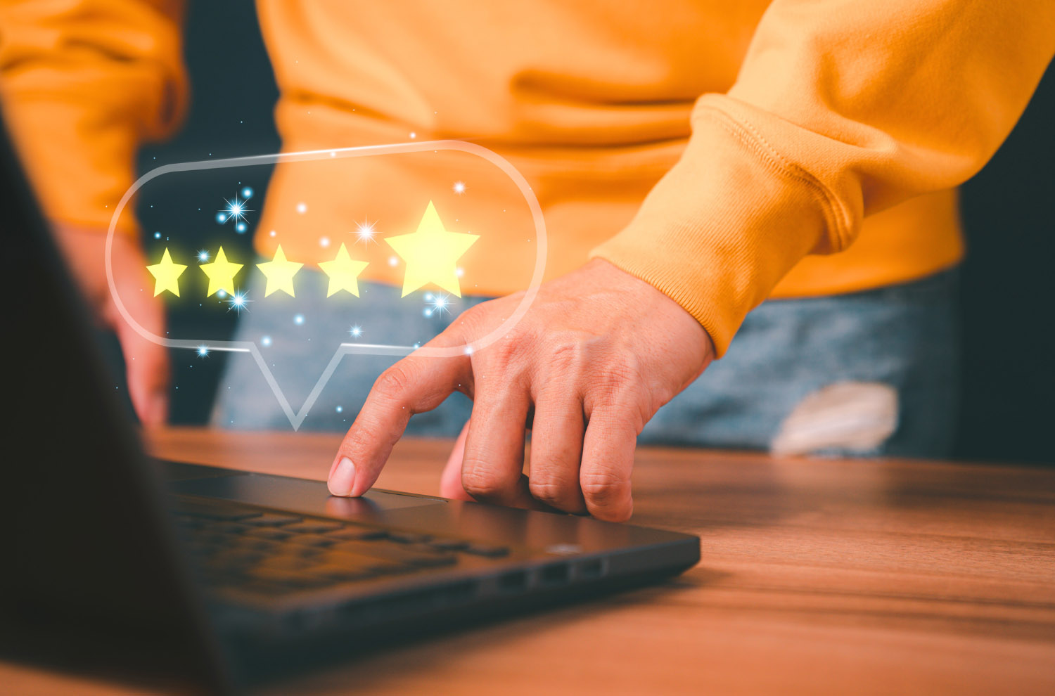 Image of Hand hovering over a laptop showing a 5-star rating