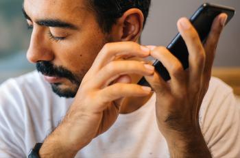 Image of a person holding a phone to their ear