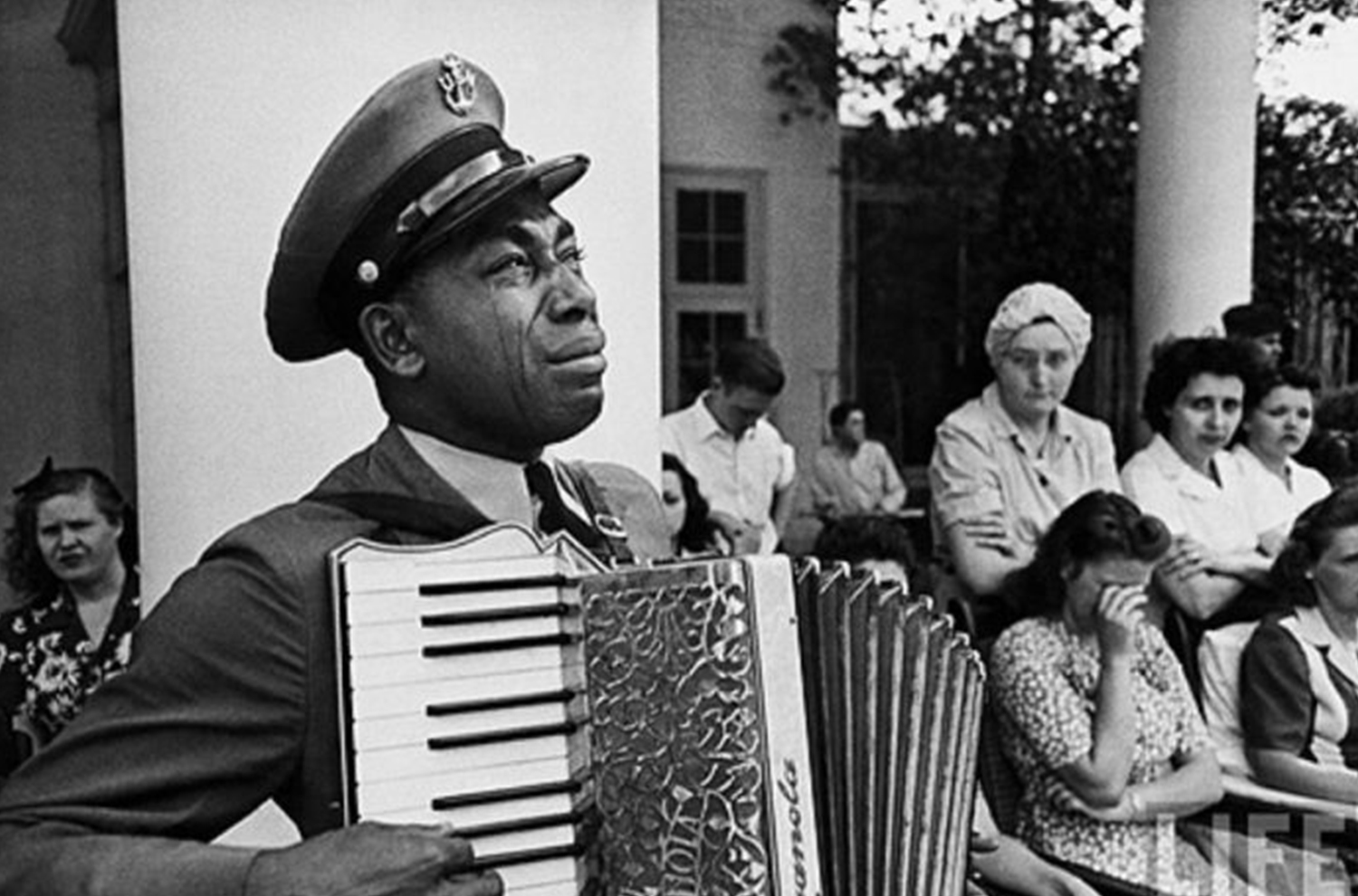 Famous photo of a man playing an instrument and crying