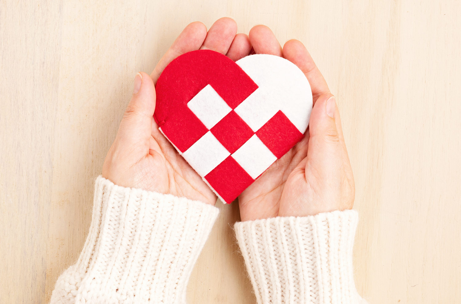 Image of Hand holding paper heart