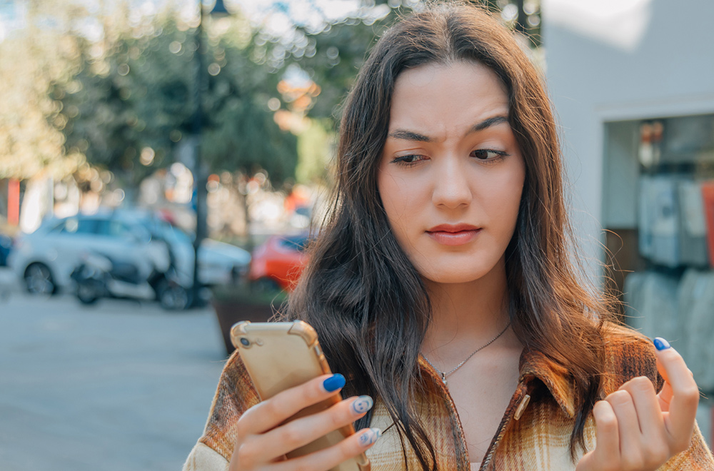 Woman looking skeptically at phone