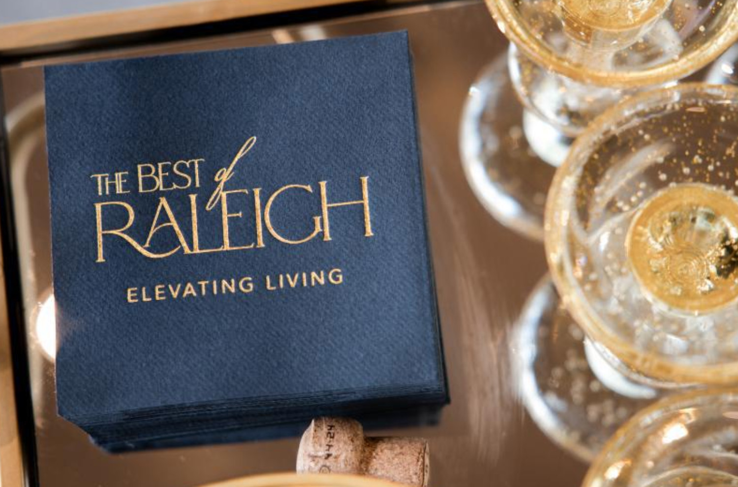 Best of Raleigh, embossed in gold on a black cocktail napkin