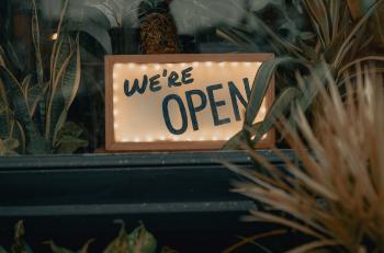Image of business sign that says 'We are open'