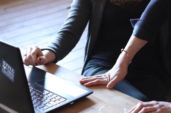 Hands on desk with laptop